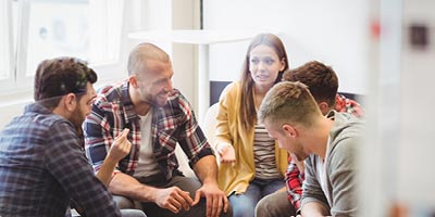 Group of millennials talking and laughing