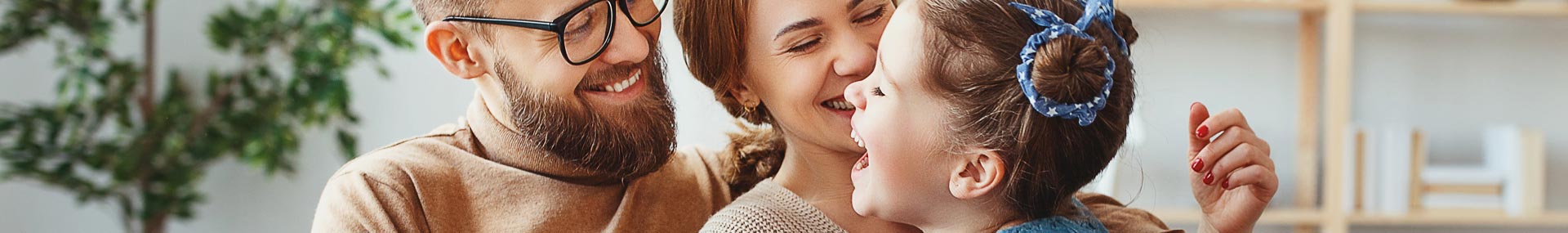 Father, mother and daughter laughing symbolizing a time of life when learning about life insurance is important.