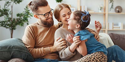 Young family at home spending quality time together and laughing. 