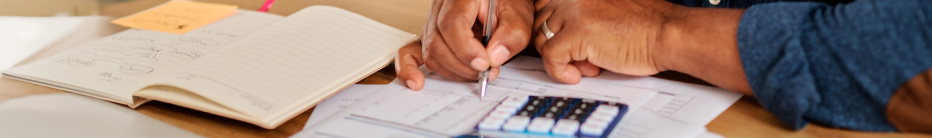 Man calculating how much term life insurance needed to financially support his family.