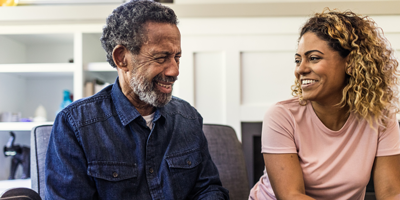 Father with his adult daughter as they discuss his decision of making his daughter his beneficiary.