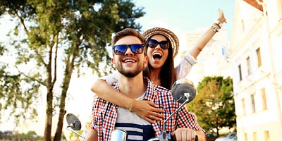 Young couple on a scooter in a foreign country