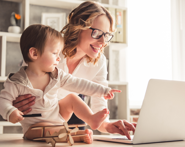 Mother and baby looking at laptop screen.