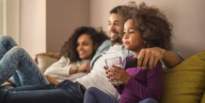 Father, mother and daughter sitting together at home.