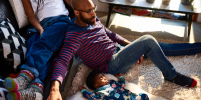 Young family of three in cozy clothing enjoying a lazy Sunday afternoon.