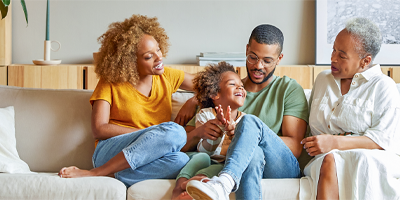 Multi-generational African American family spending time together in a living room