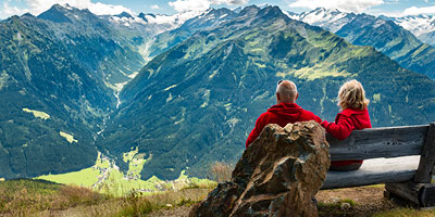 Older couple viewing mountain range, leveraging flexible life insurance benefits while still alive