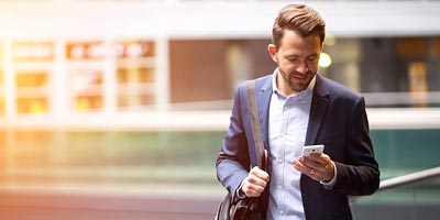 Business man looking at his smartphone.