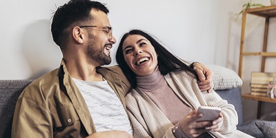 Couple sitting on the couch. laughing together