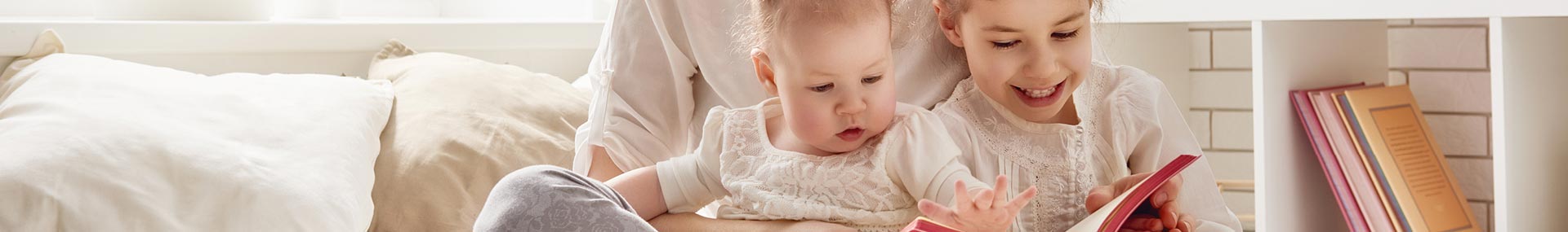 Mother on couch with baby and young daughter indicating they need to plan for their family’s future with the new baby.
