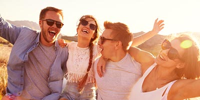Two young couples out on a beautiful evening, shouting and having fun.