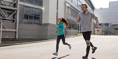 A young couple out for a jog in the city.