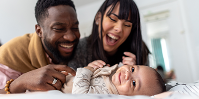 Young couple playing with their new baby