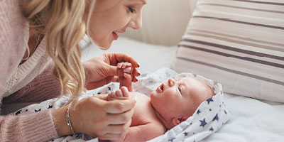 Mother playing with her special needs child for whom she has tailored her financial plans. 