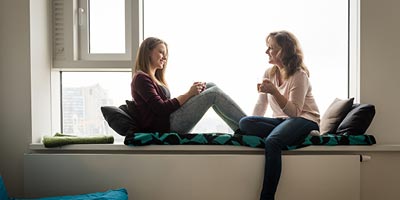 Mother and Teen Daughter talking while relaxing