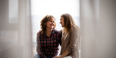 Mom sitting on porch with adult daughter