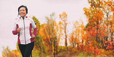 Asian woman going on a jog on a fall day.