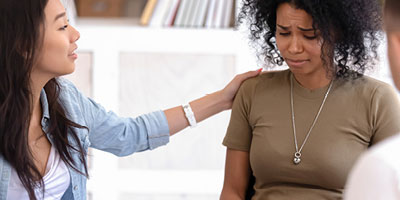 Friend consoling her friend that just lost her job and isn’t sure if she has mortgage insurance. 