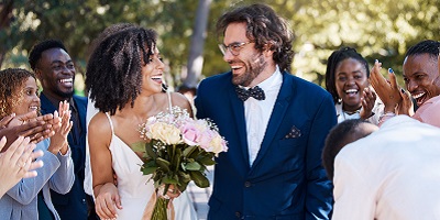 Bride and groom smiling lovingly at one another on their wedding day