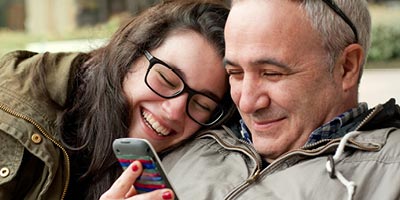 Happy daughter and father share a hug