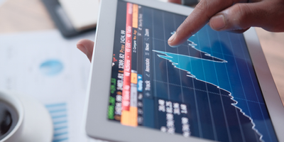 A visual of screens displaying graphs of stock performance.