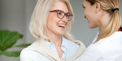 Older woman laughing with daughter