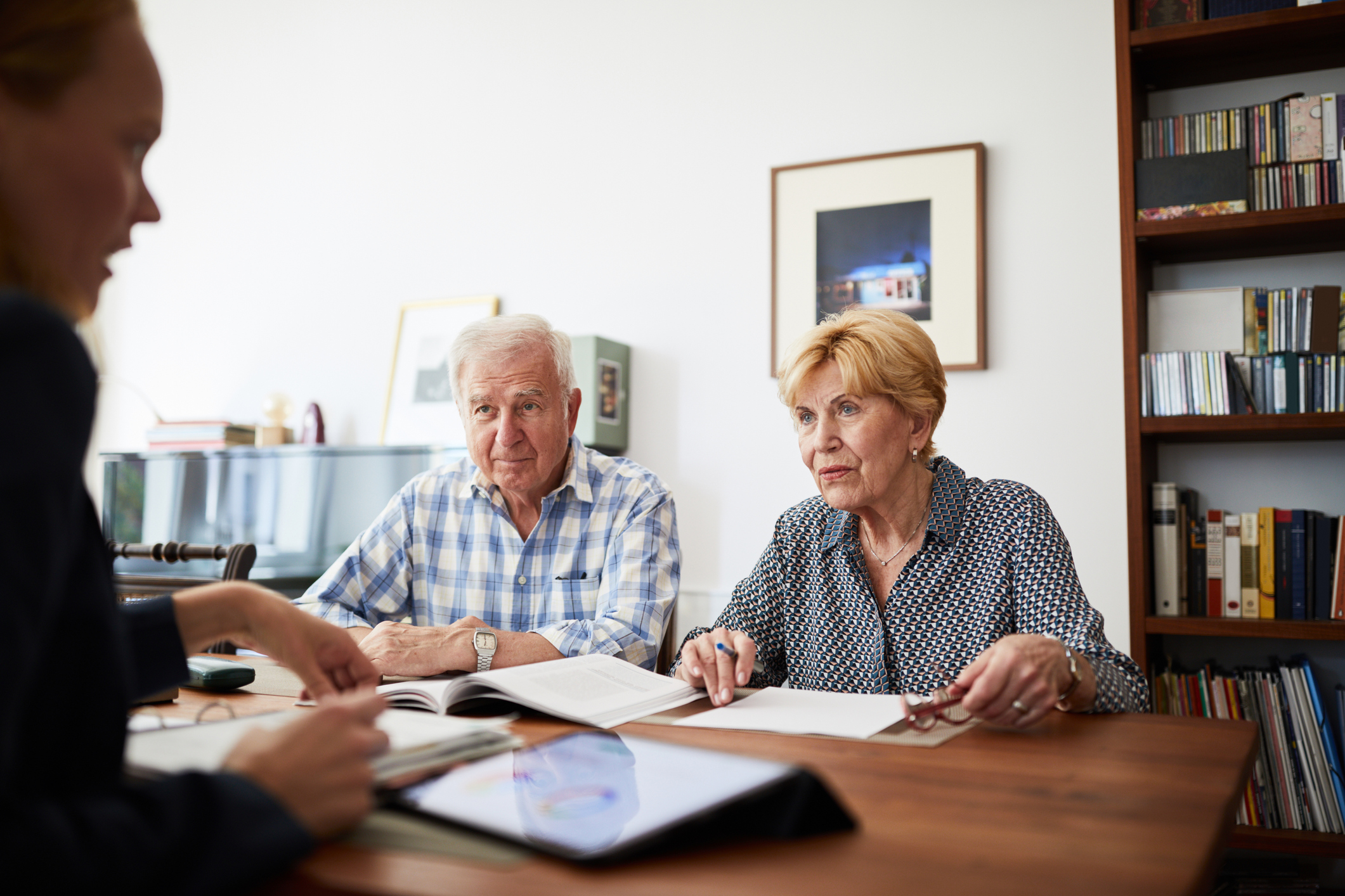 A senior adult couple speaking with an attorney to discuss power of attorney. 