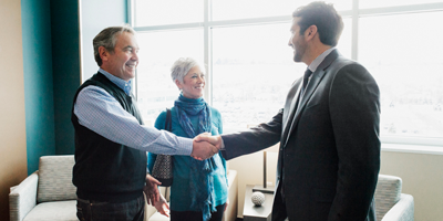 A senior adult couple meeting with their financial advisor to discuss annuity payment options. 