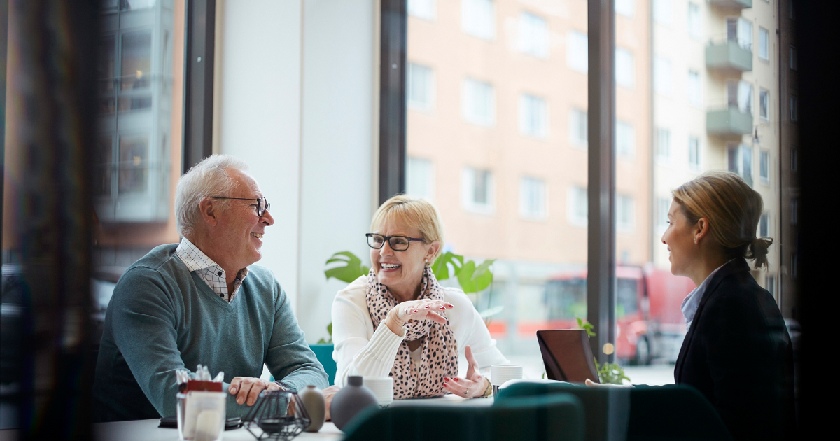 Older couple at a table with female financial advisor.