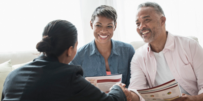Smiling older couple meeting with a financial advisor