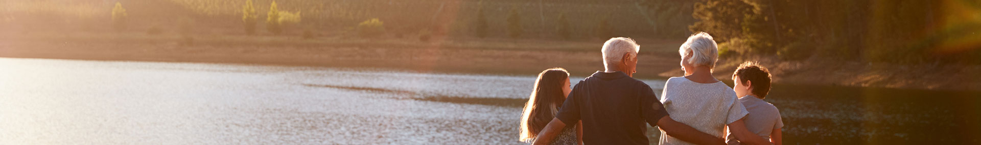 Grandparents with grandchildren symbolizing how planning your wills and estate can benefit the next generation.