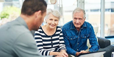Senior couple sits with their financial professional discussing annuities