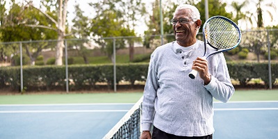 Retired man happily leaving the court after a tennis match