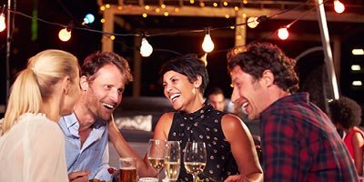 Two couples ranging from thirties to forties enjoying a dinner date.