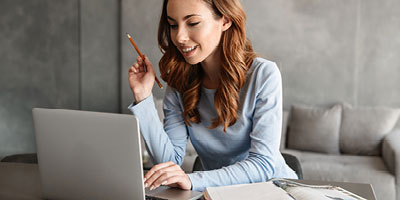 Young woman at work reading about the difference between a pension plan and a 401K.