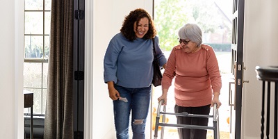 Adult daughter moving her elderly mom into the house