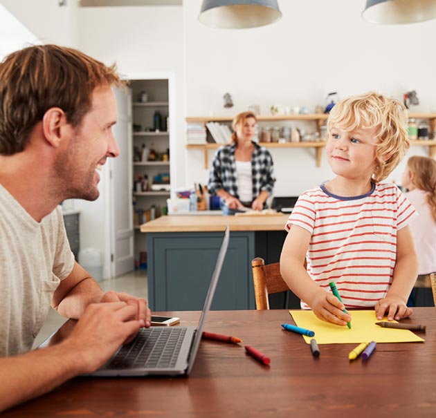 Father shares a smile with his son at the kitchen table