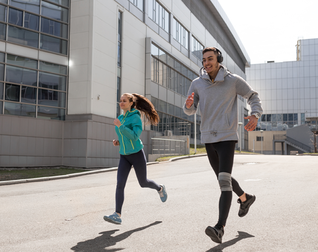 Young, athletic couple running