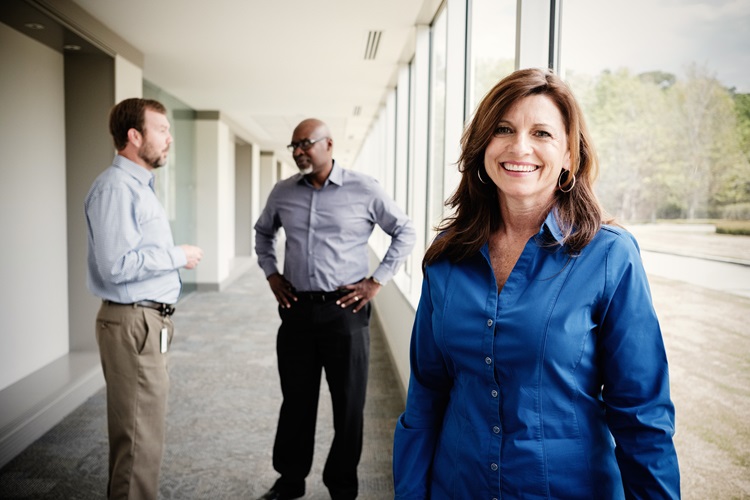 Protective Life employees talking in a hallway.