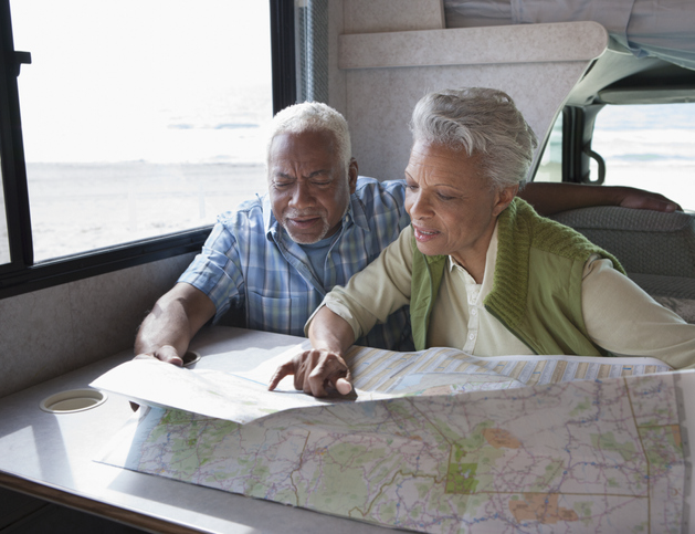 Older couple reviewing map from inside RV