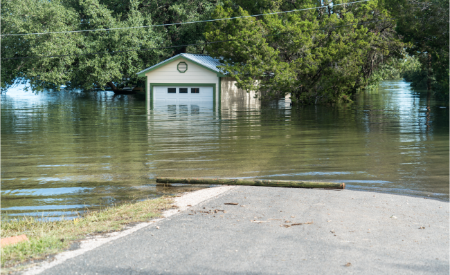House and road underwater due to flooding.