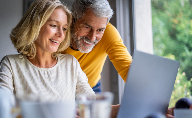 A couple using a laptop to manage their annuity.